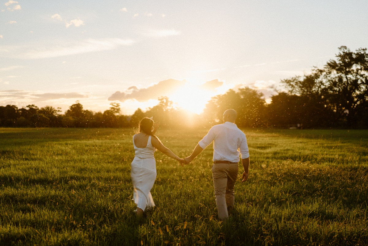 A lovely couple walking off into the sunset at their driftwood shed wedding.