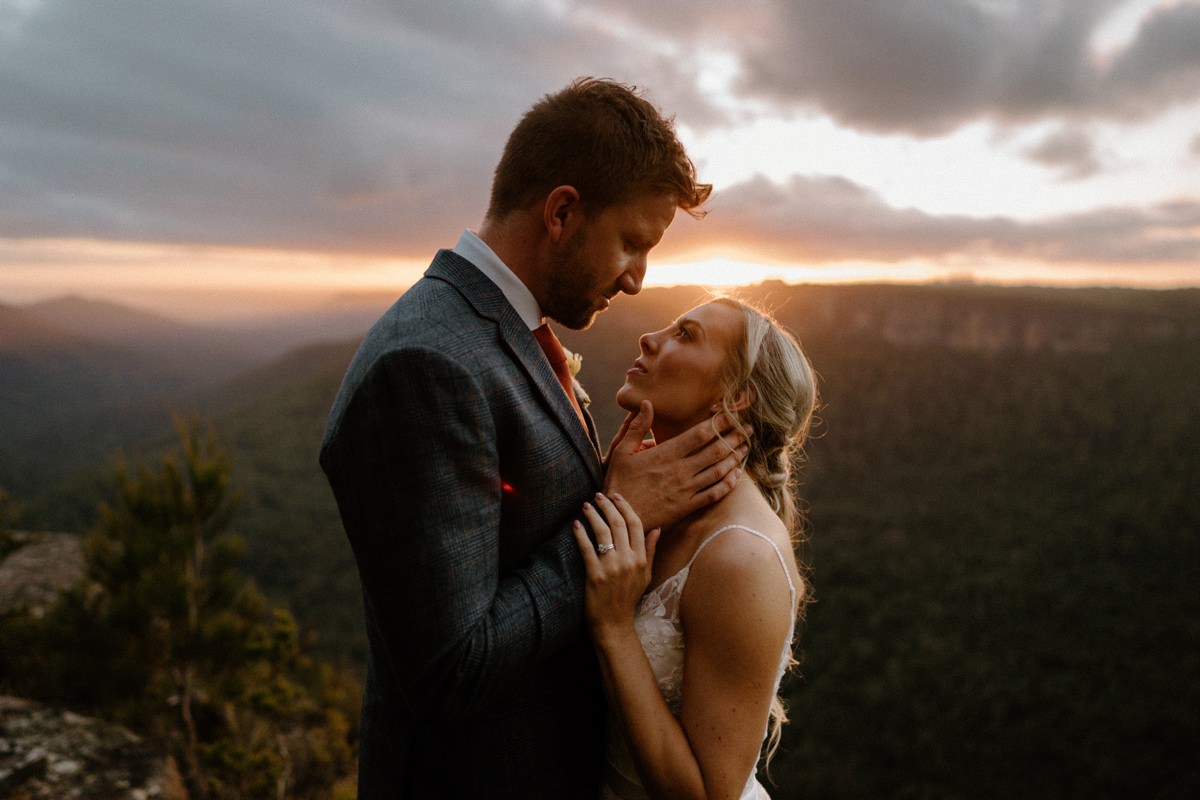 A recently wedded couple overlooking a mountain range at kangaroo valley at their bodycotts lane wedding