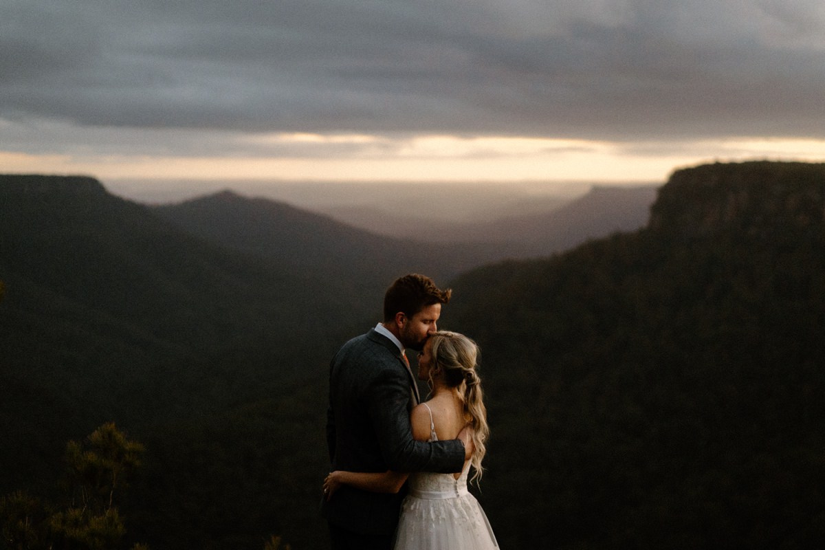 A recently wedded couple overlooking a mountain range at kangaroo valley at their bodycotts lane wedding