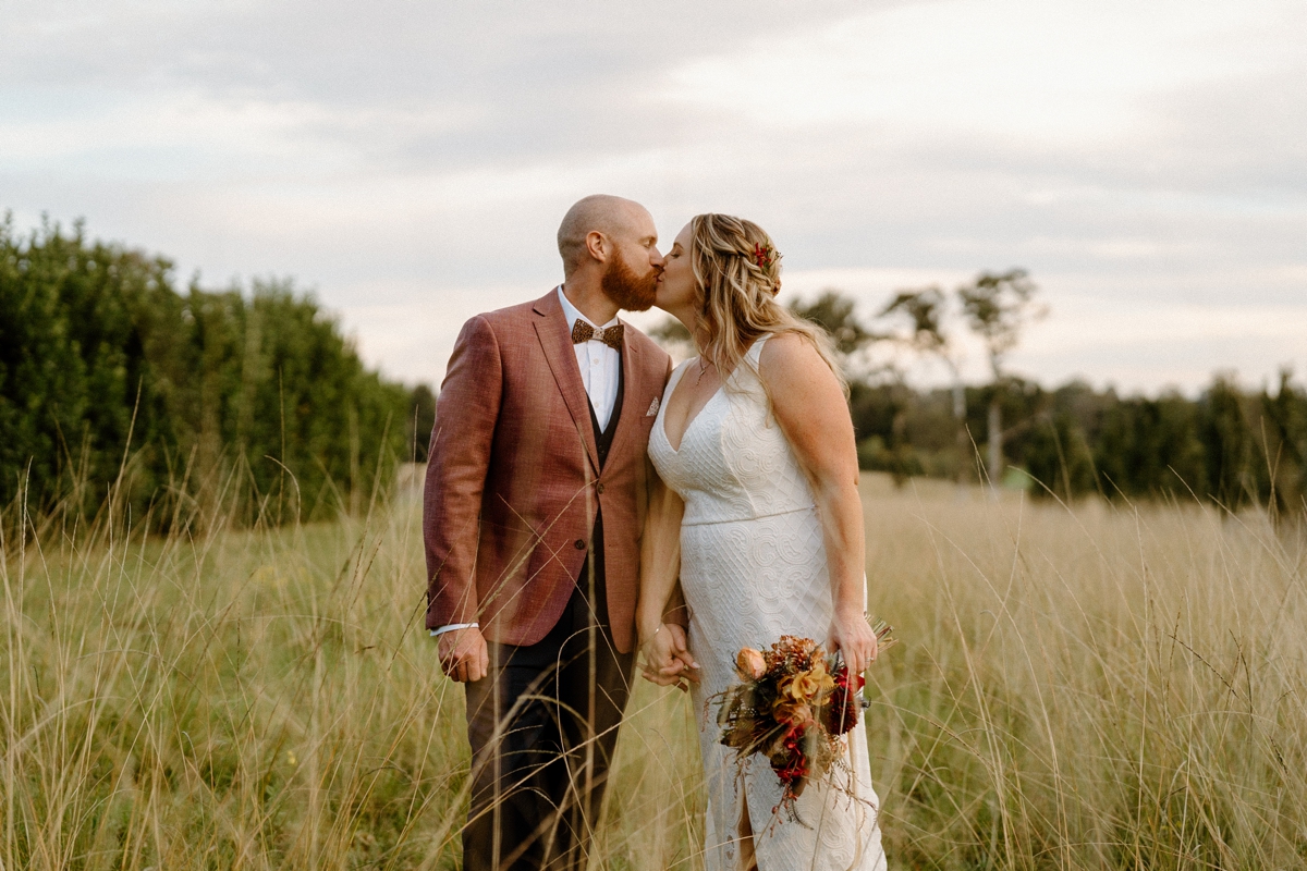 a beautiful bride and groom in a field at their south coast backyard wedding.