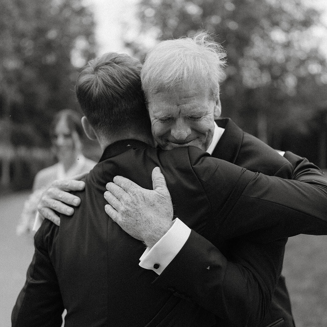 A photo of a groom emotionally hugging his father at his southern highlands wedding. They are both crying!